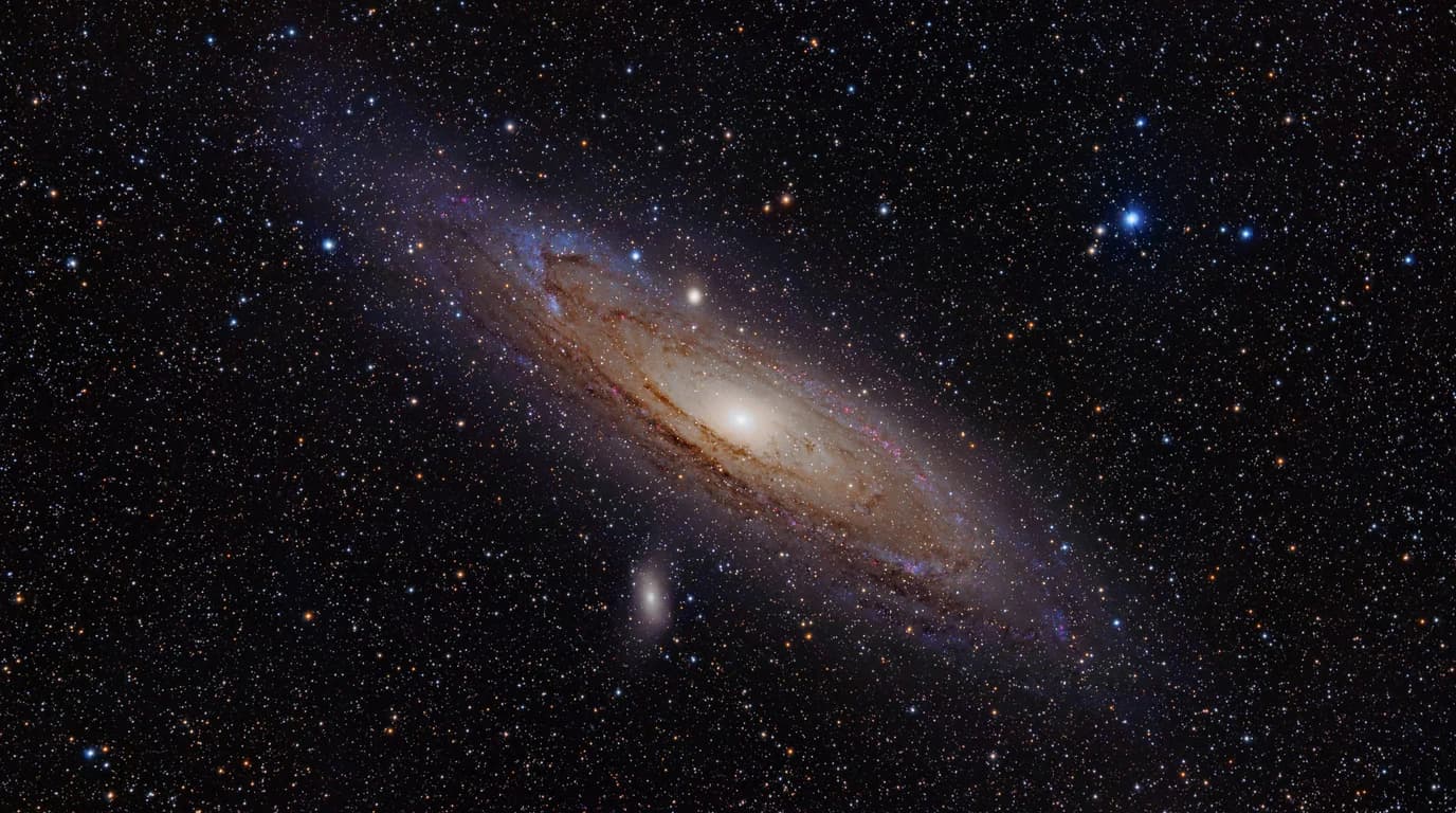 The Andromeda galaxy seen at an angle, full spiral arms and bright core visible.