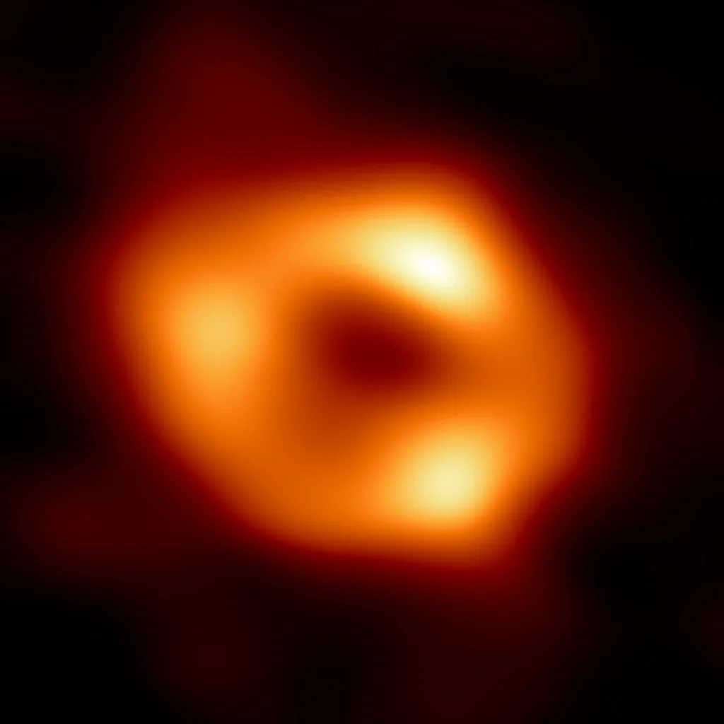 A supermassive black hole — a black sphere ringed by a glowing accretion disk.